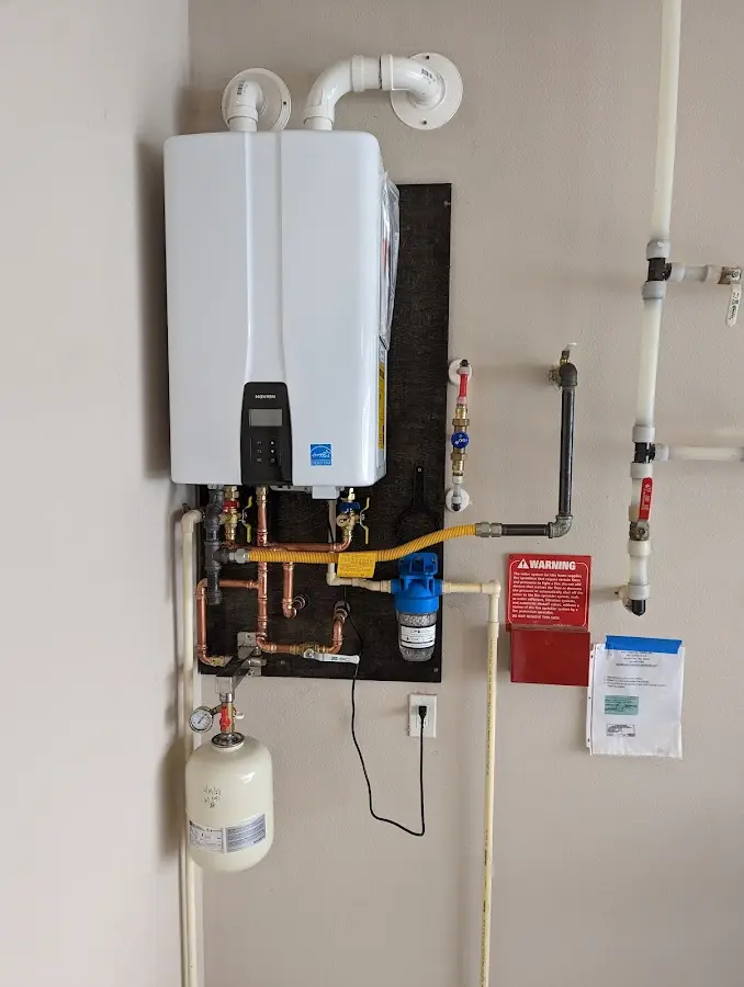 Professional plumber installing copper piping in a Essex home